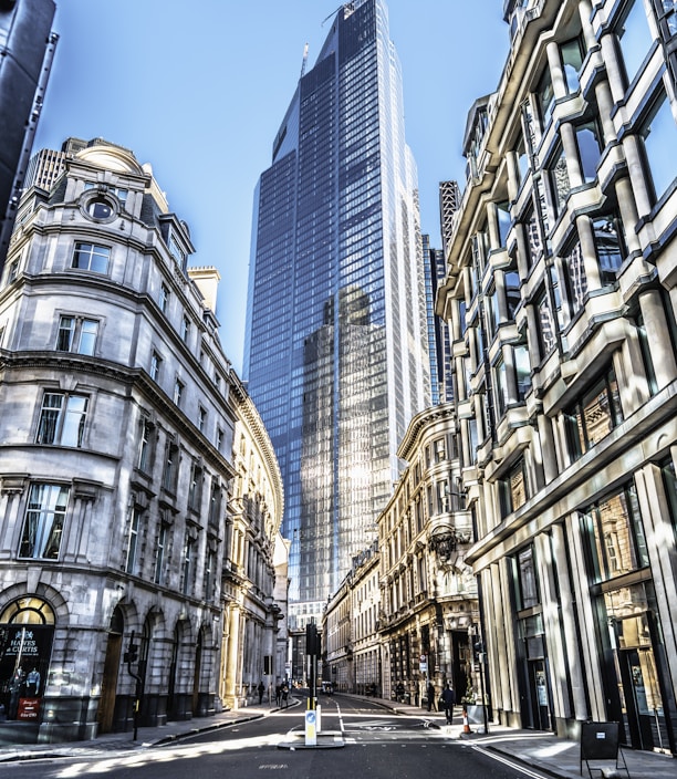 people walking on street between high rise buildings during daytime