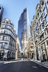 people walking on street between high rise buildings during daytime