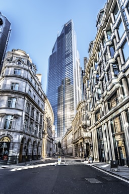 people walking on street between high rise buildings during daytime