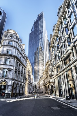people walking on street between high rise buildings during daytime