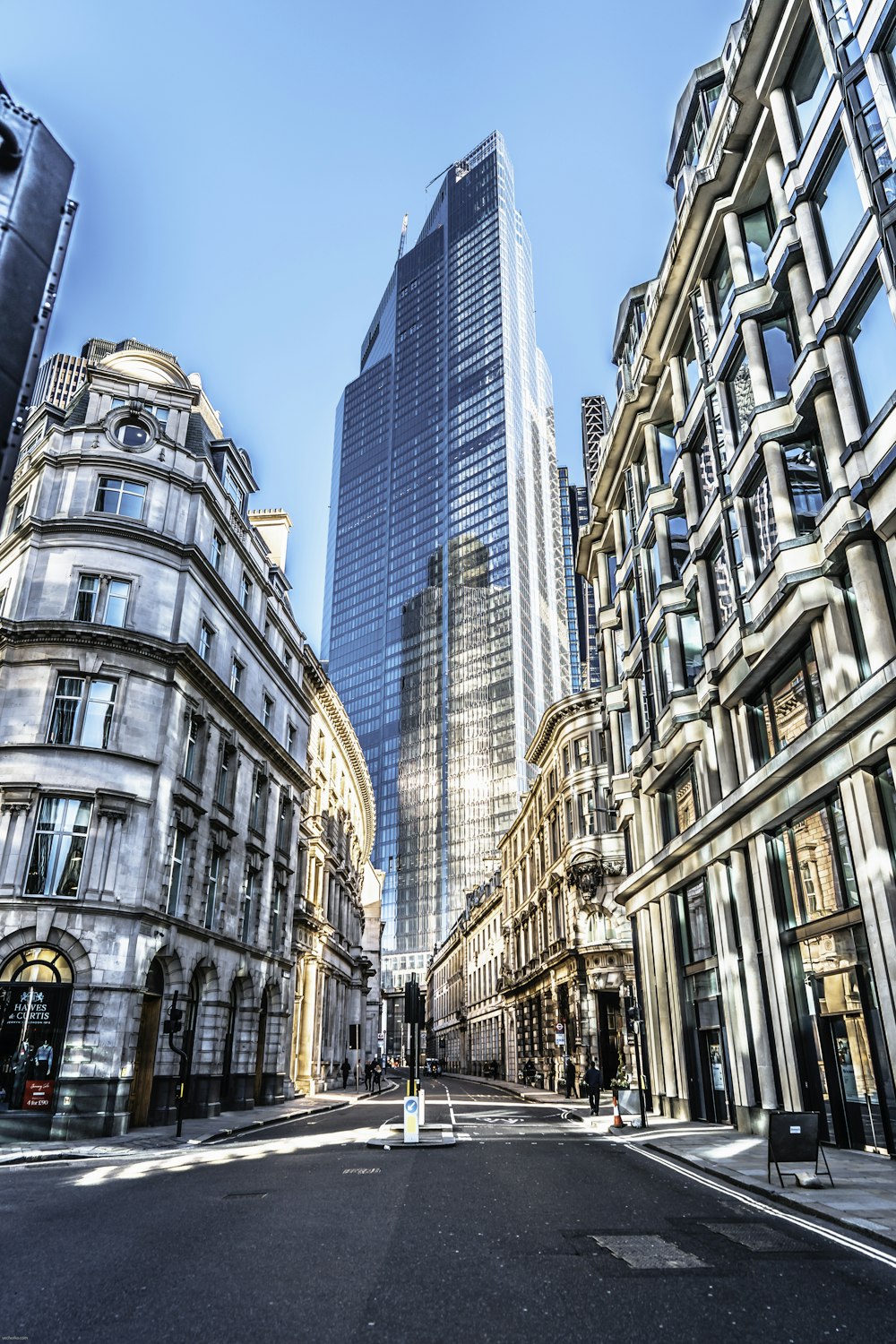 people walking on street between high rise buildings during daytime