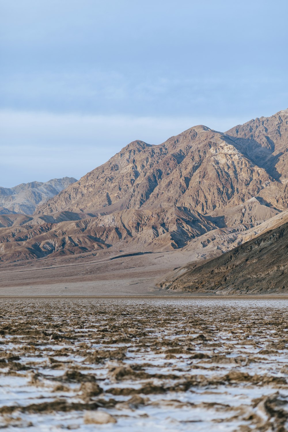 brown mountains near body of water during daytime