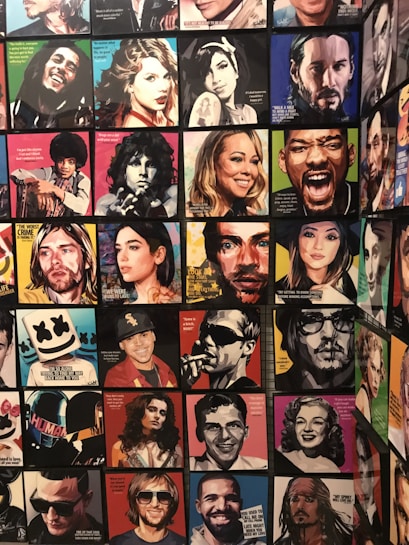 A collection of colorful, pop art-style portraits depicting various famous individuals, each with a distinct color scheme and artistic text quotes overlaying the images. The arrangement includes a vibrant mix of contemporary and classic figures, with each portrait emphasizing facial expressions and unique stylistic representations.