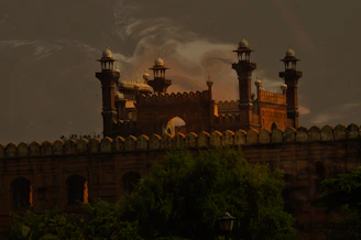 A beautifully decorated royal wedding mandap set against the historic fort backdrop at sunset.