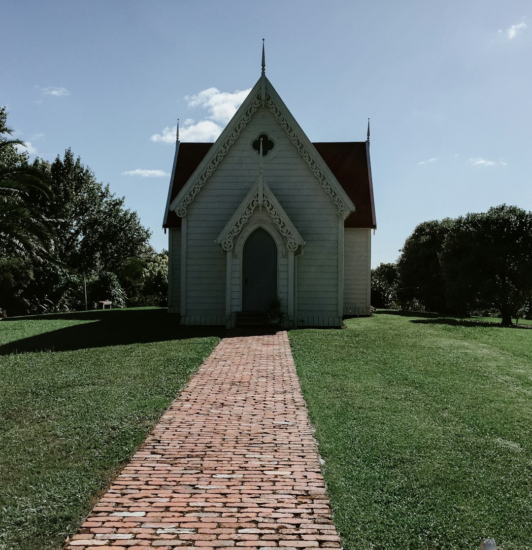 green grass field near brown brick building