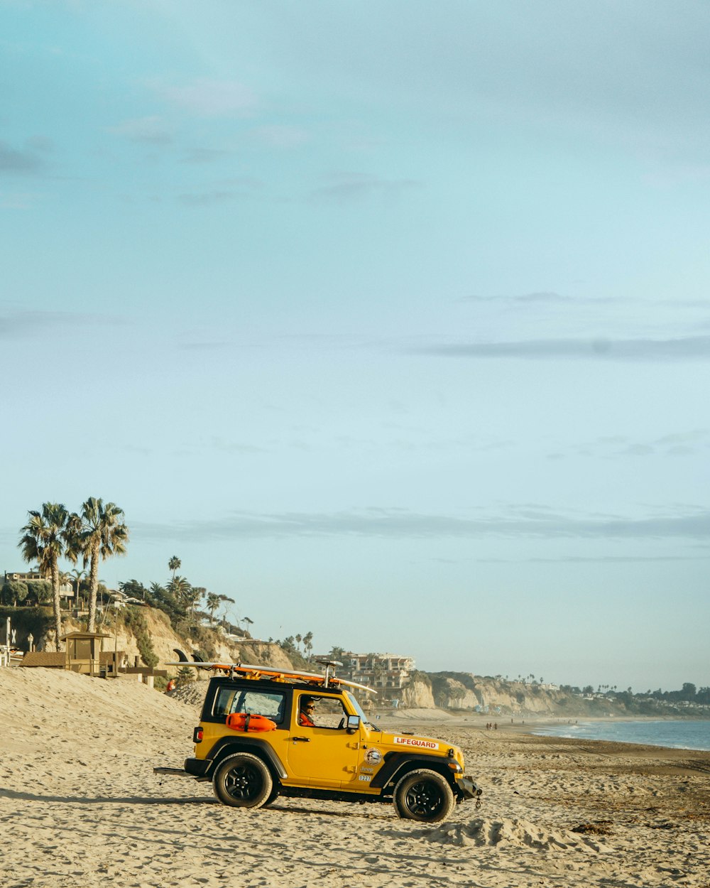 yellow jeep wrangler on beach during daytime