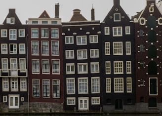 A completed row of townhouses showcasing varied architectural styles.