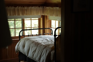 A cozy bedroom featuring a stylish wooden bed frame.