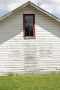 red wooden window on white wooden house