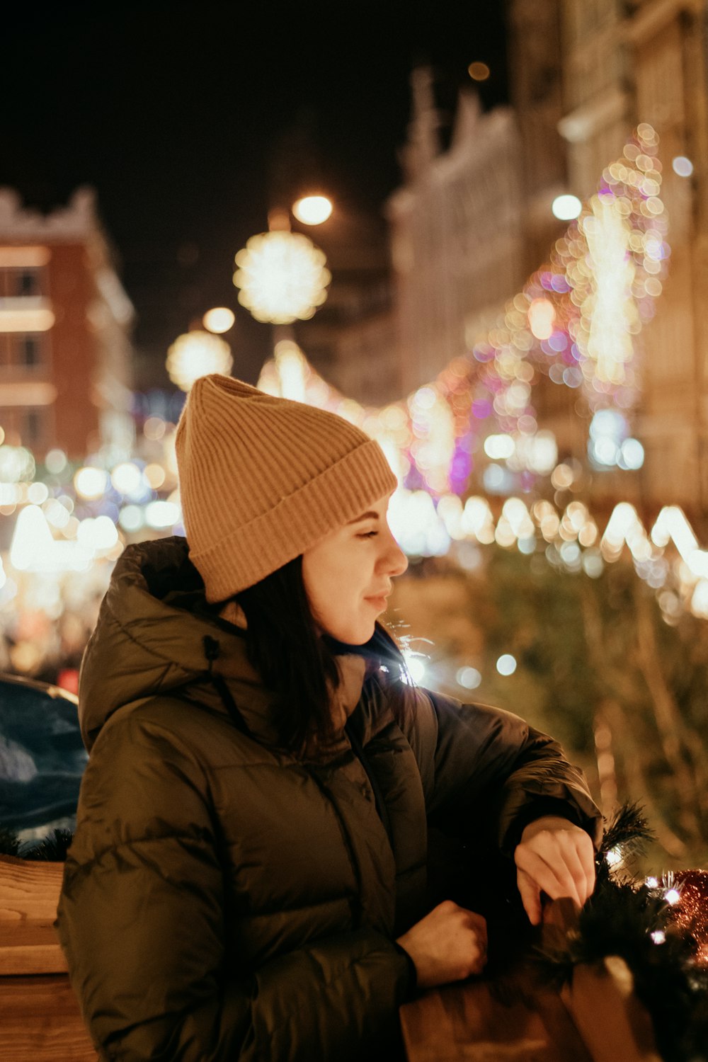 woman in brown knit cap and black jacket