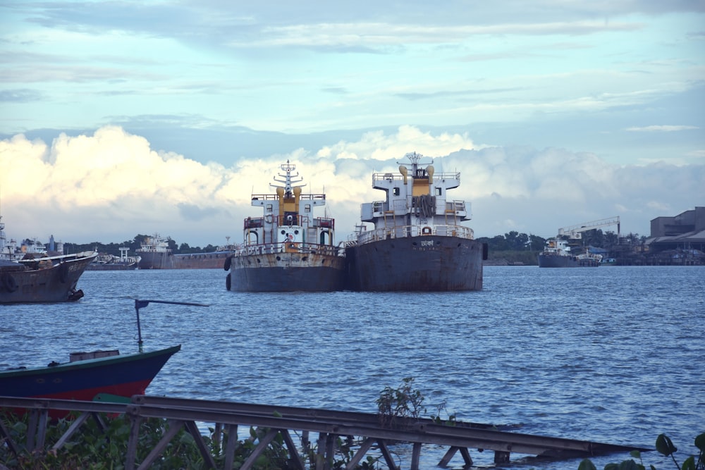 brown ship on sea under blue sky and white clouds during daytime