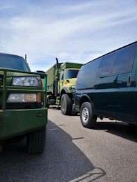 A modern fleet of navy and charcoal trucks lined up, ready for departure under a clear Galway sky.