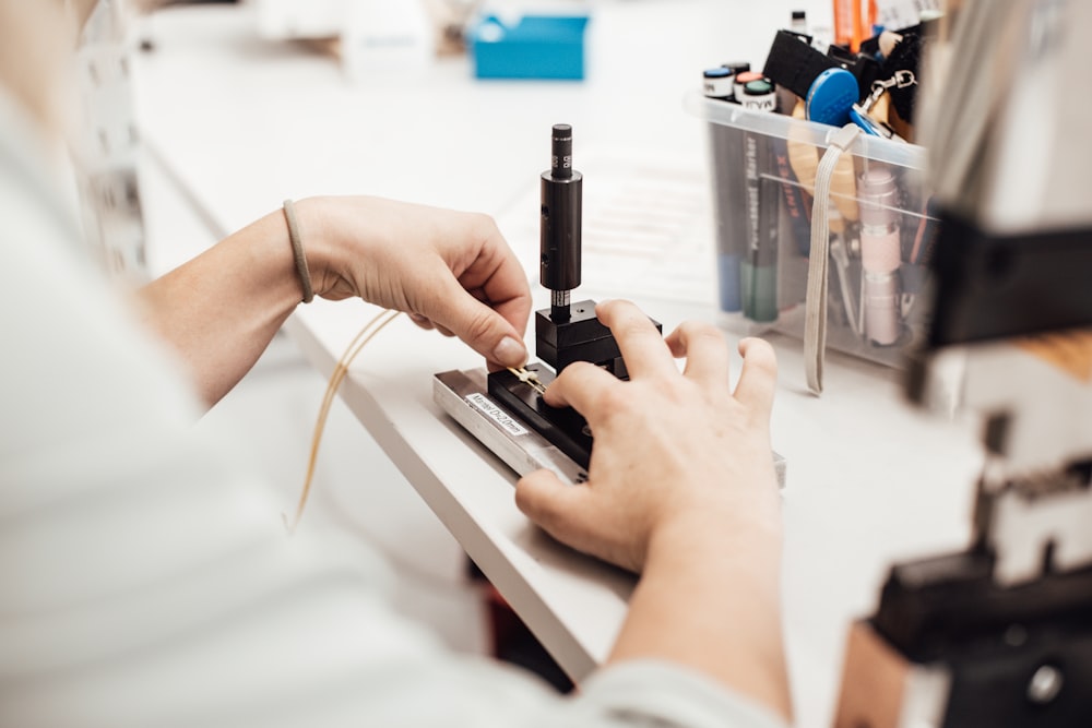 person holding black tube type mod