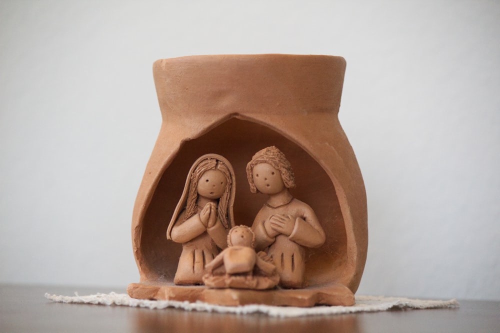 brown ceramic angel figurine on white table