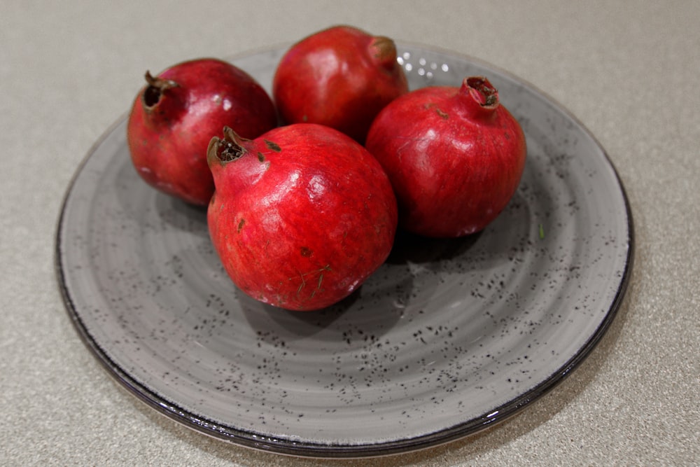 red fruits on white ceramic plate