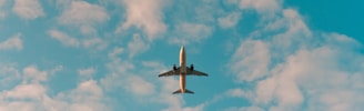 white airplane flying in the sky during daytime