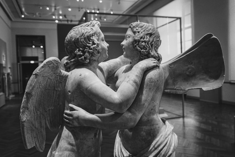 grayscale photo of woman and child statue