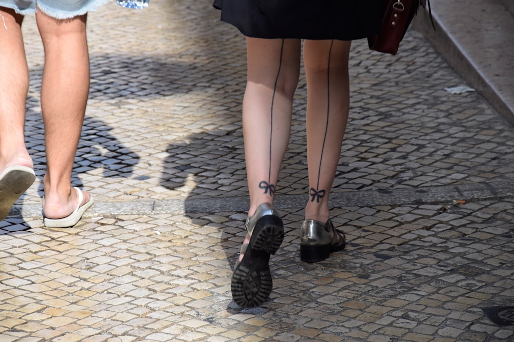 woman in black skirt and black leather shoes