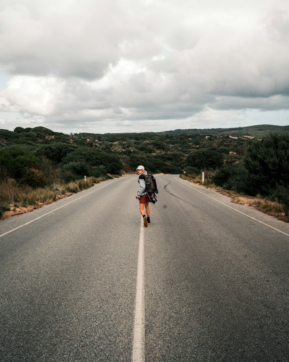 man in black jacket and black pants riding bicycle on gray asphalt road during daytime