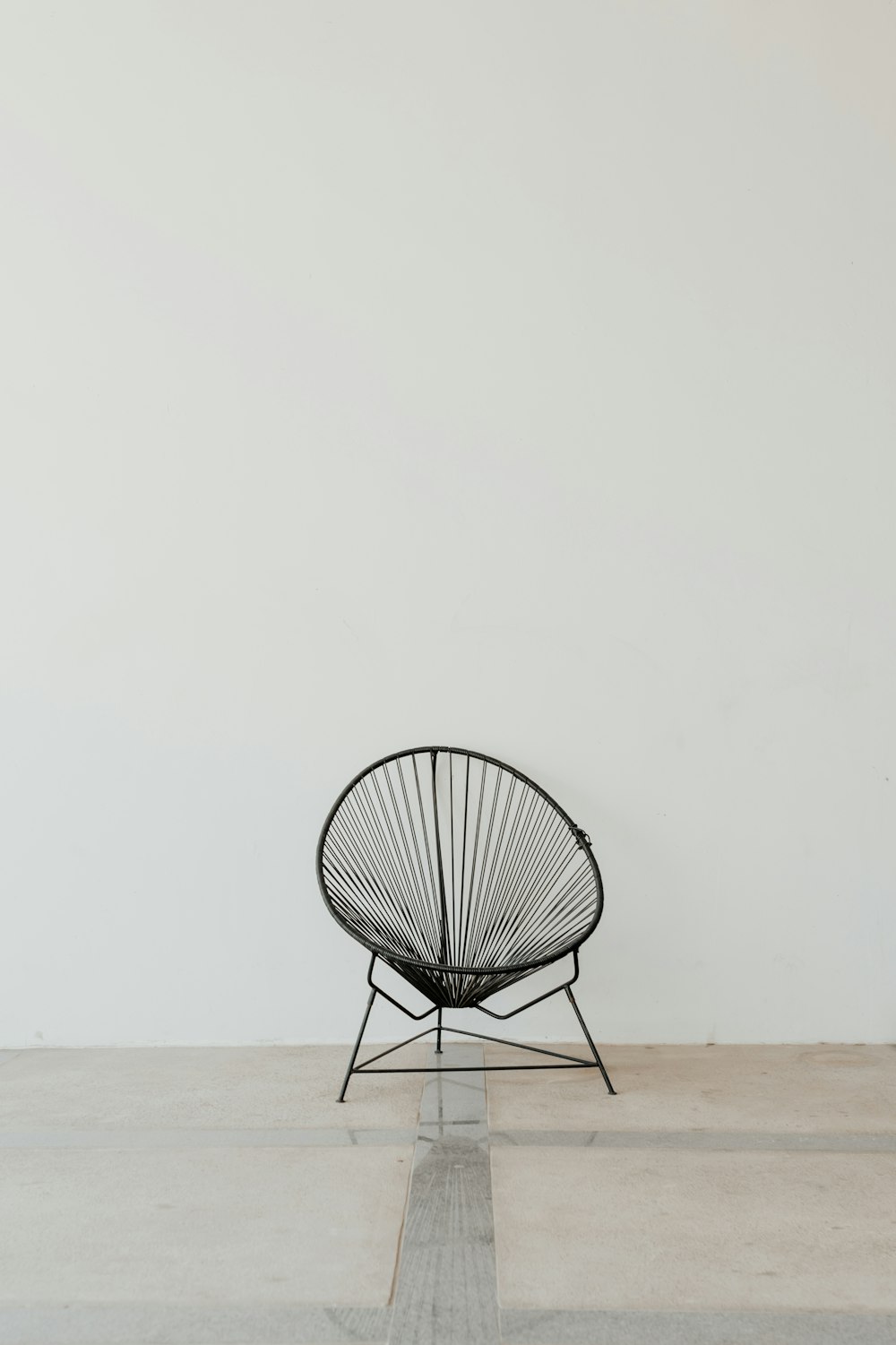 black metal chair on brown sand