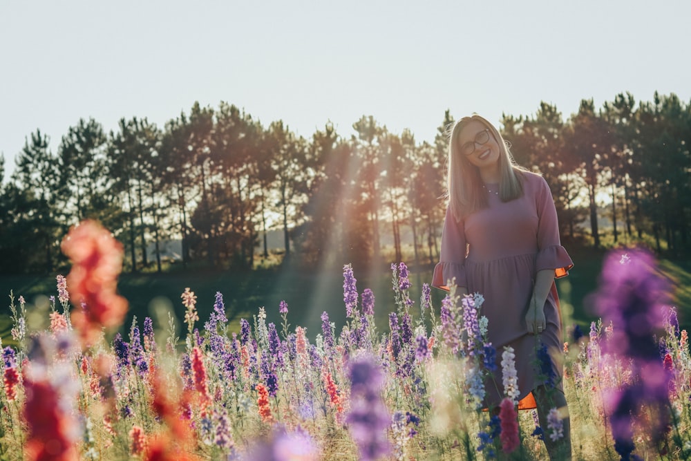 woman in black long sleeve shirt standing on purple flower field during daytime