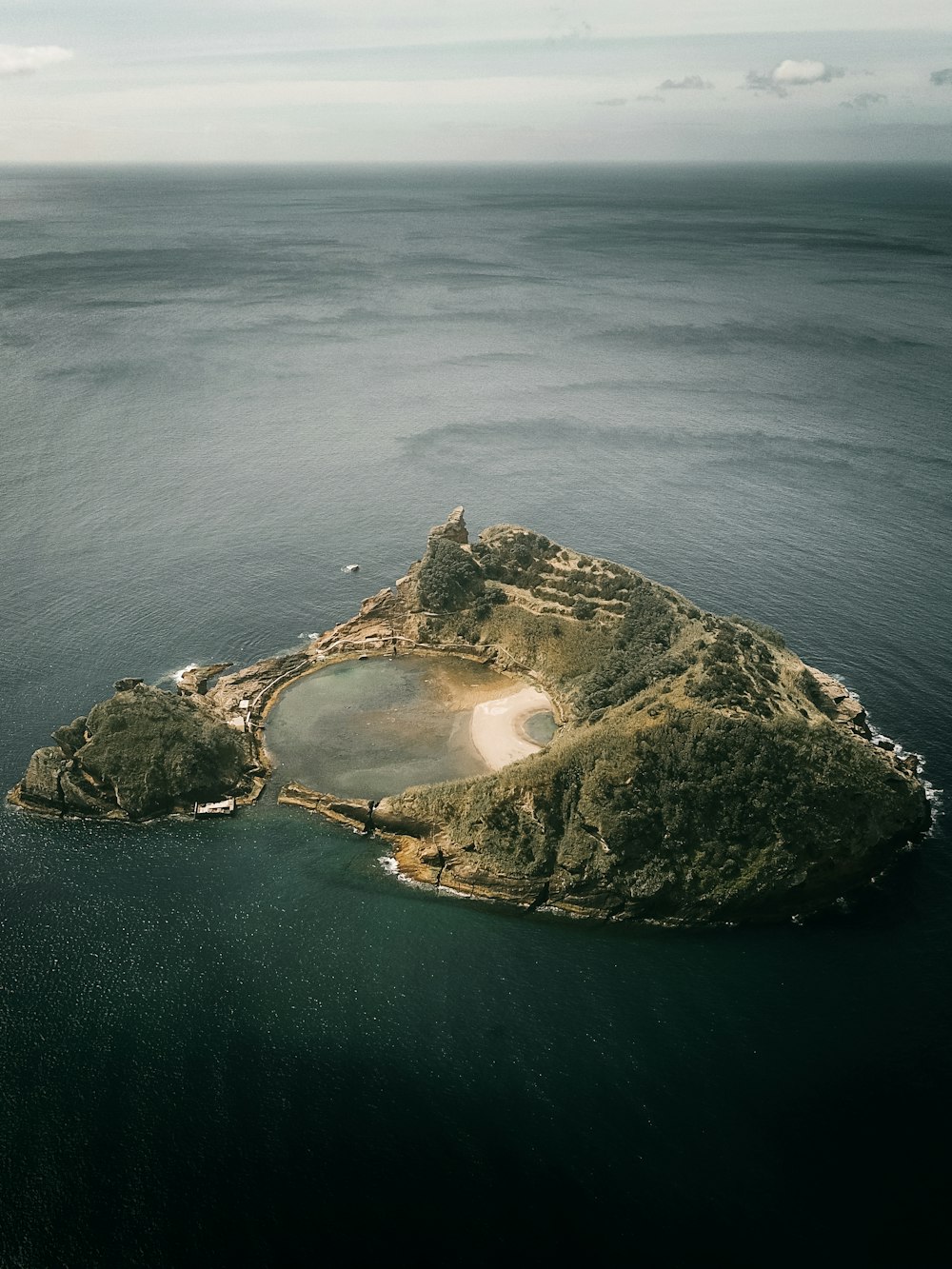 aerial view of island in the middle of ocean