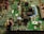 A close-up view of an electronic circuit board featuring various components such as capacitors, resistors, and integrated circuits. The board is mostly green with metallic elements, showing a complex array of electronic architecture.