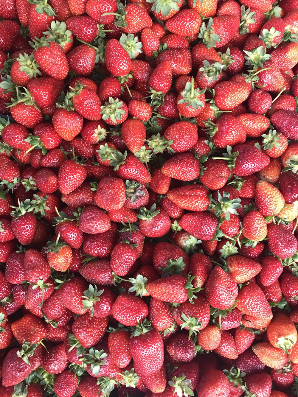 red strawberries on white ceramic plate