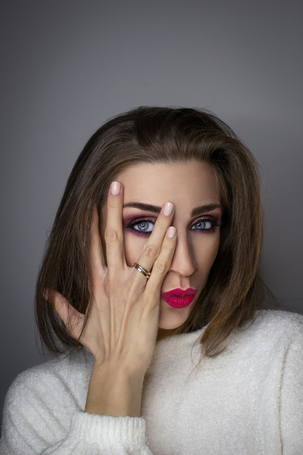 woman in white sweater with red lipstick