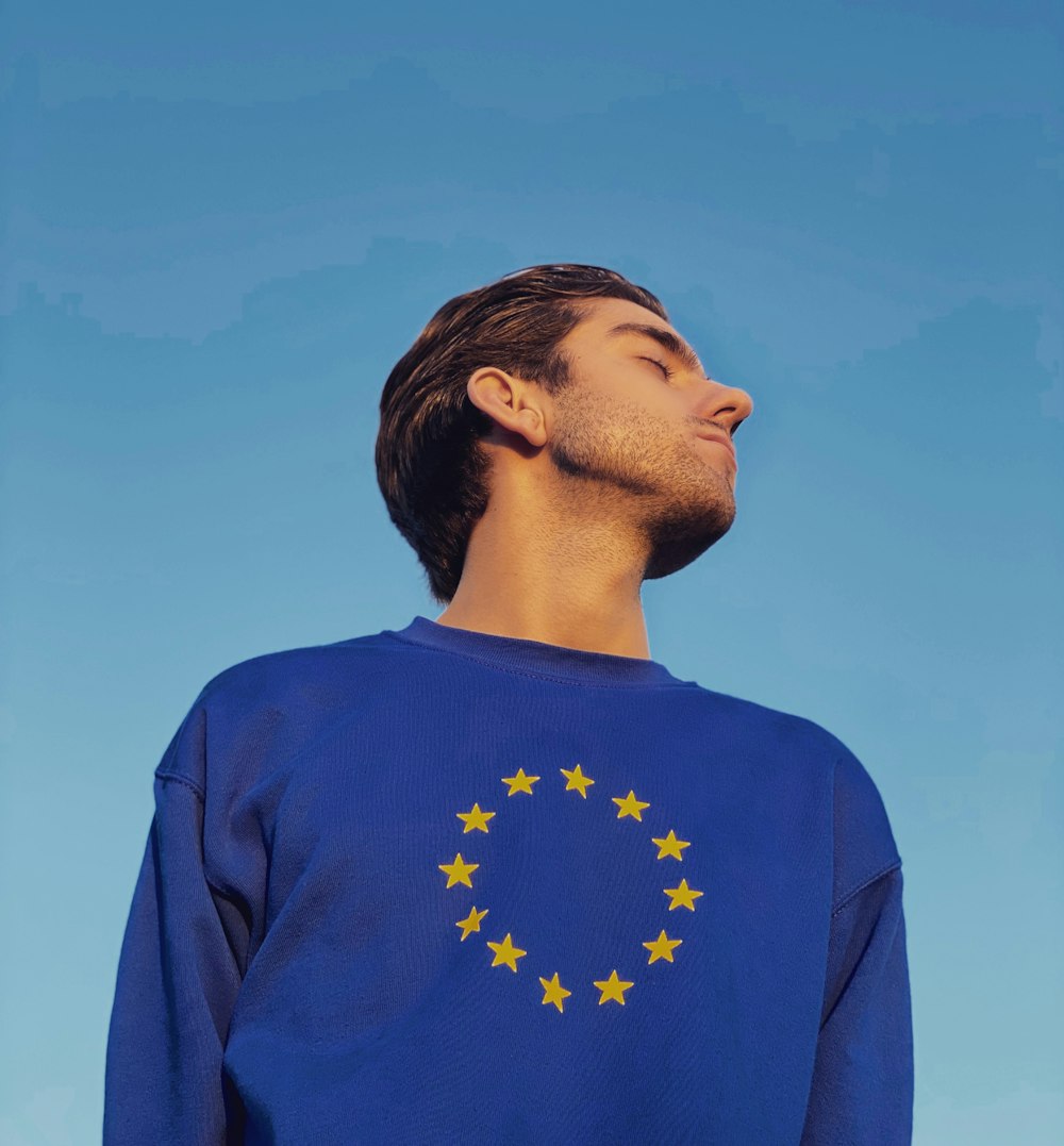 man in blue crew neck shirt under blue sky during daytime