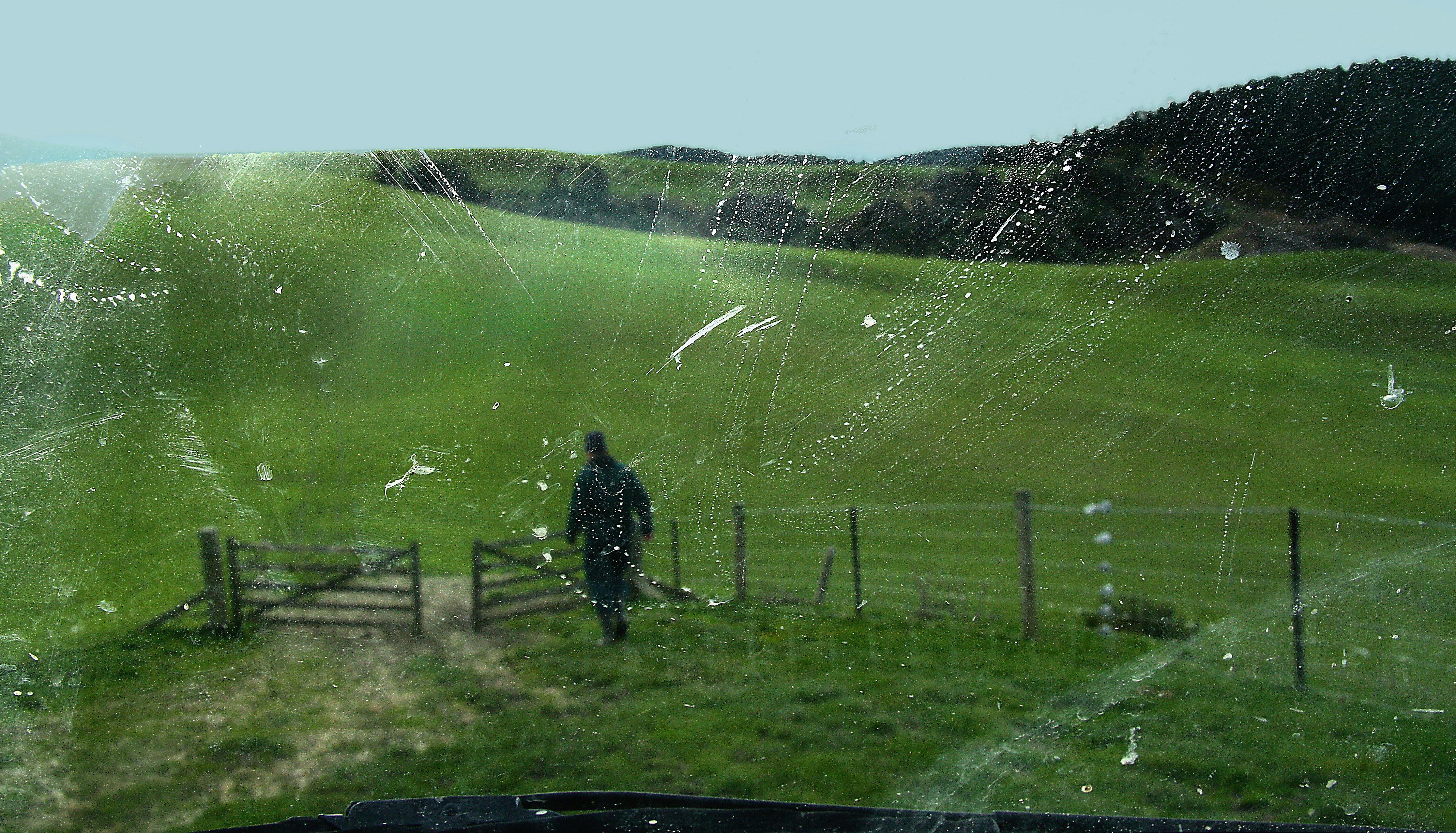 man in black jacket standing on green grass field during daytime