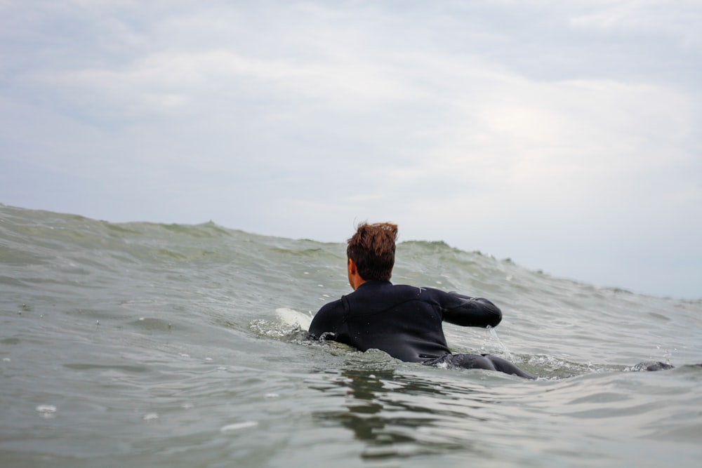 woman in black long sleeve shirt in water