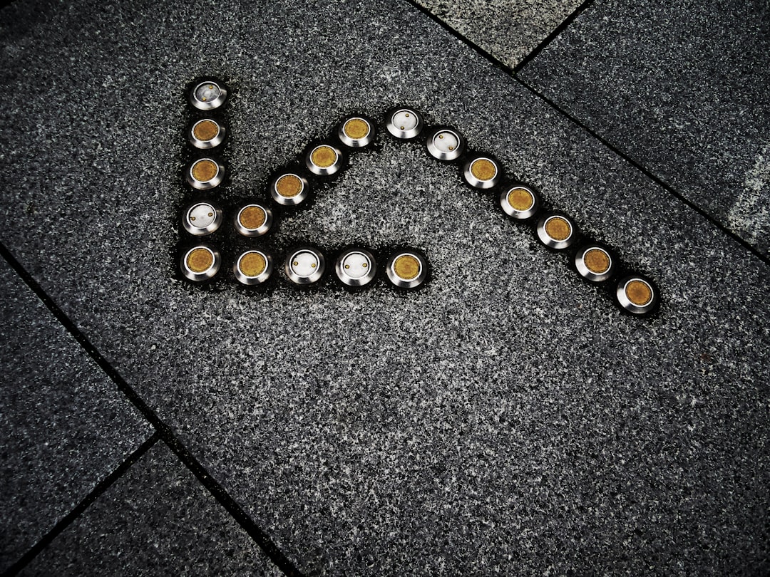 black and yellow round beads on gray concrete floor