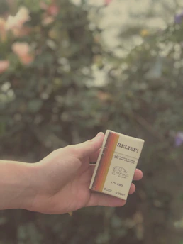 Satisfied customer holding a pack of asaprasa cigarettes with a smile.