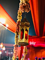 An intimate henna night setup with golden lanterns casting warm glows over guests in elegant attire.