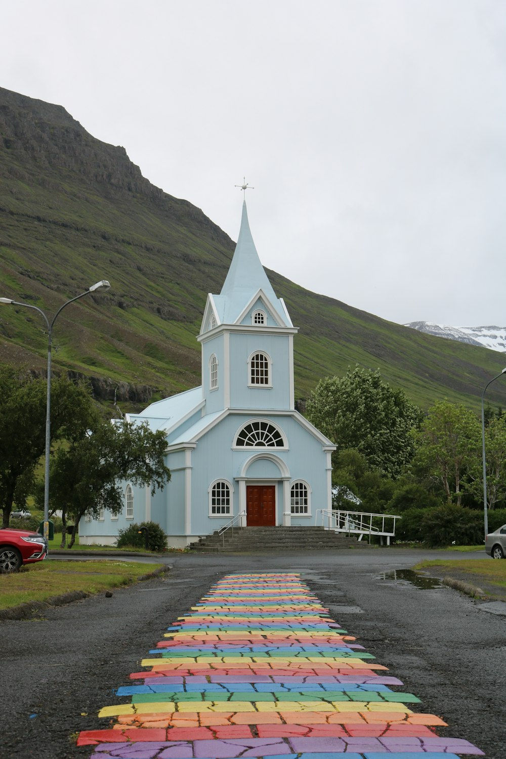 white and black church near green mountains during daytime