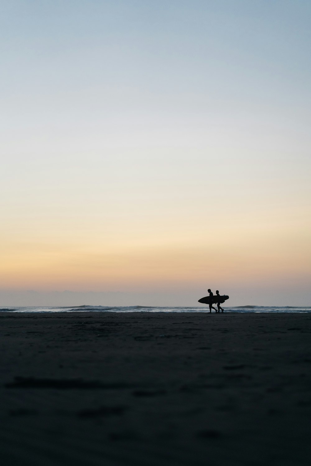 Person, die bei Sonnenuntergang am Strand zu Pferd reitet
