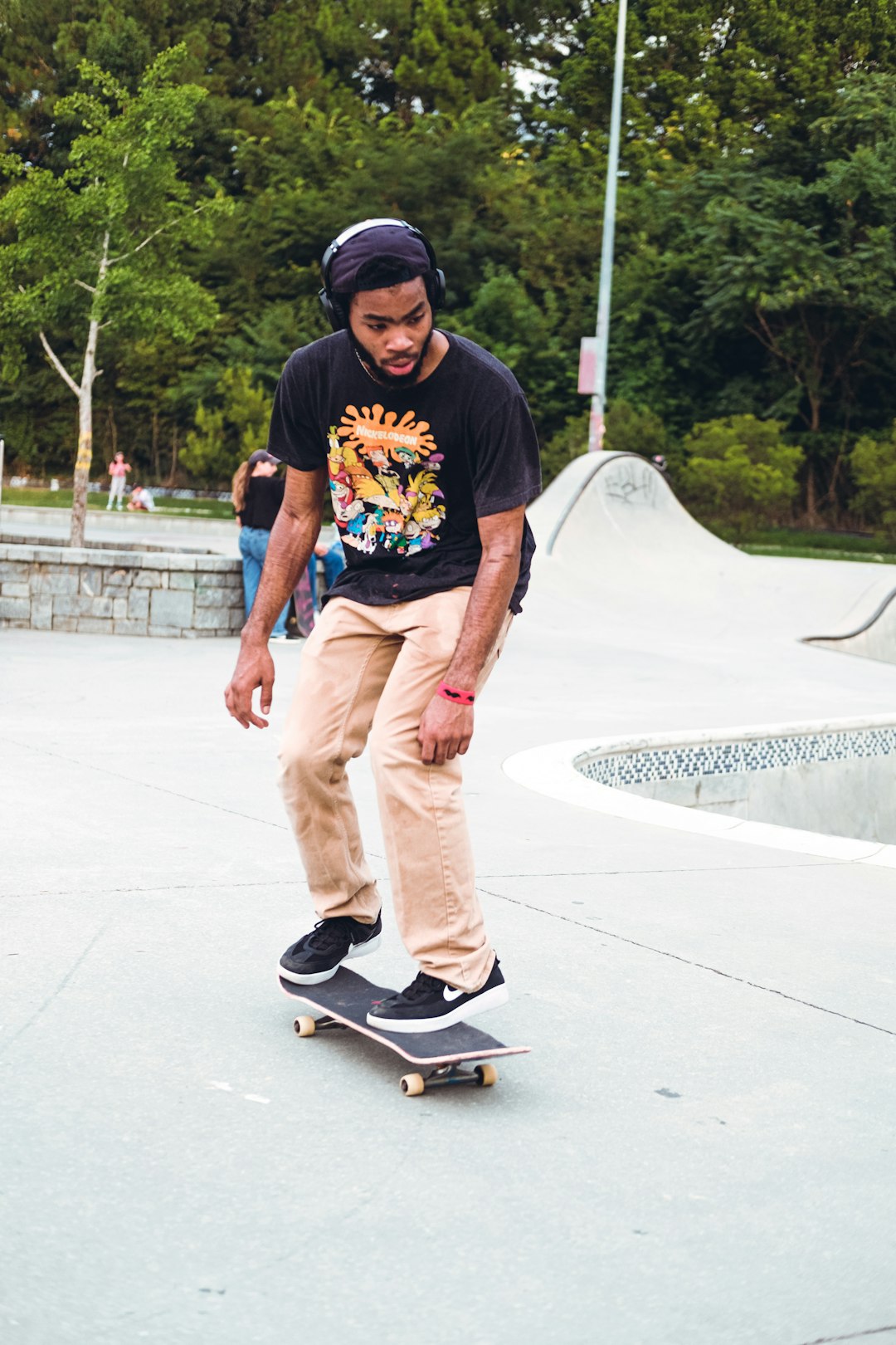 man in black crew neck t-shirt and brown pants riding skateboard during daytime