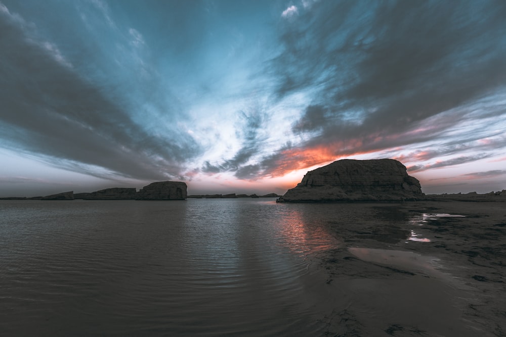 body of water under cloudy sky during daytime