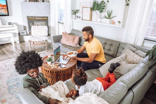 A cozy living room with a family using a laptop and enjoying the internet.