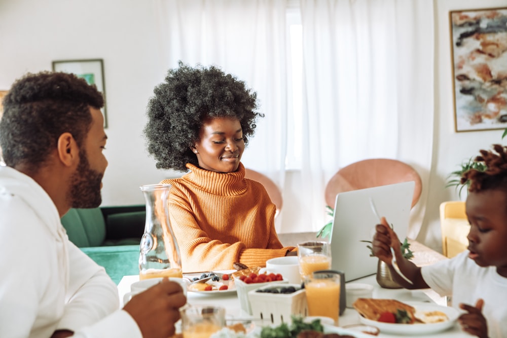 woman in brown sweater sitting beside man in white dress shirt