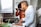 Close-up of a joyful man tasting a colorful Brazilian dish in a cozy kitchen setting.