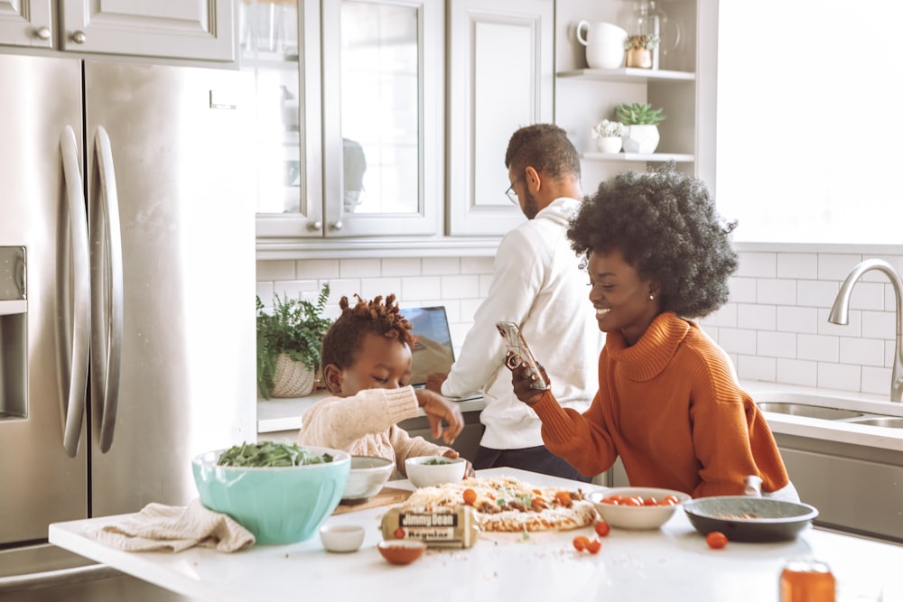 man in white dress shirt sitting beside woman in orange long sleeve shirt eating