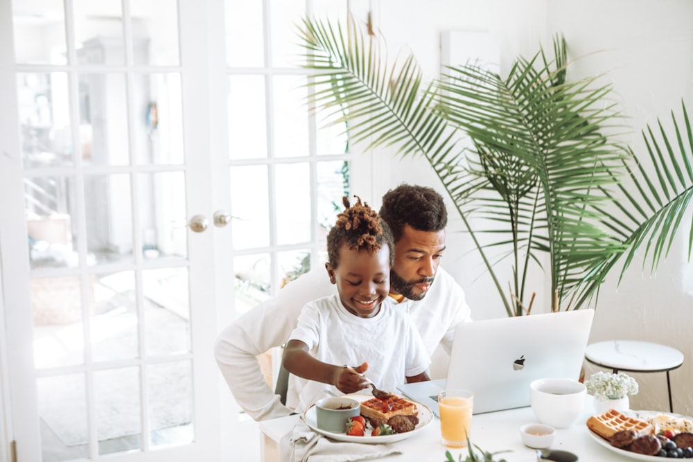 man in white long sleeve shirt holding girl in white long sleeve shirt