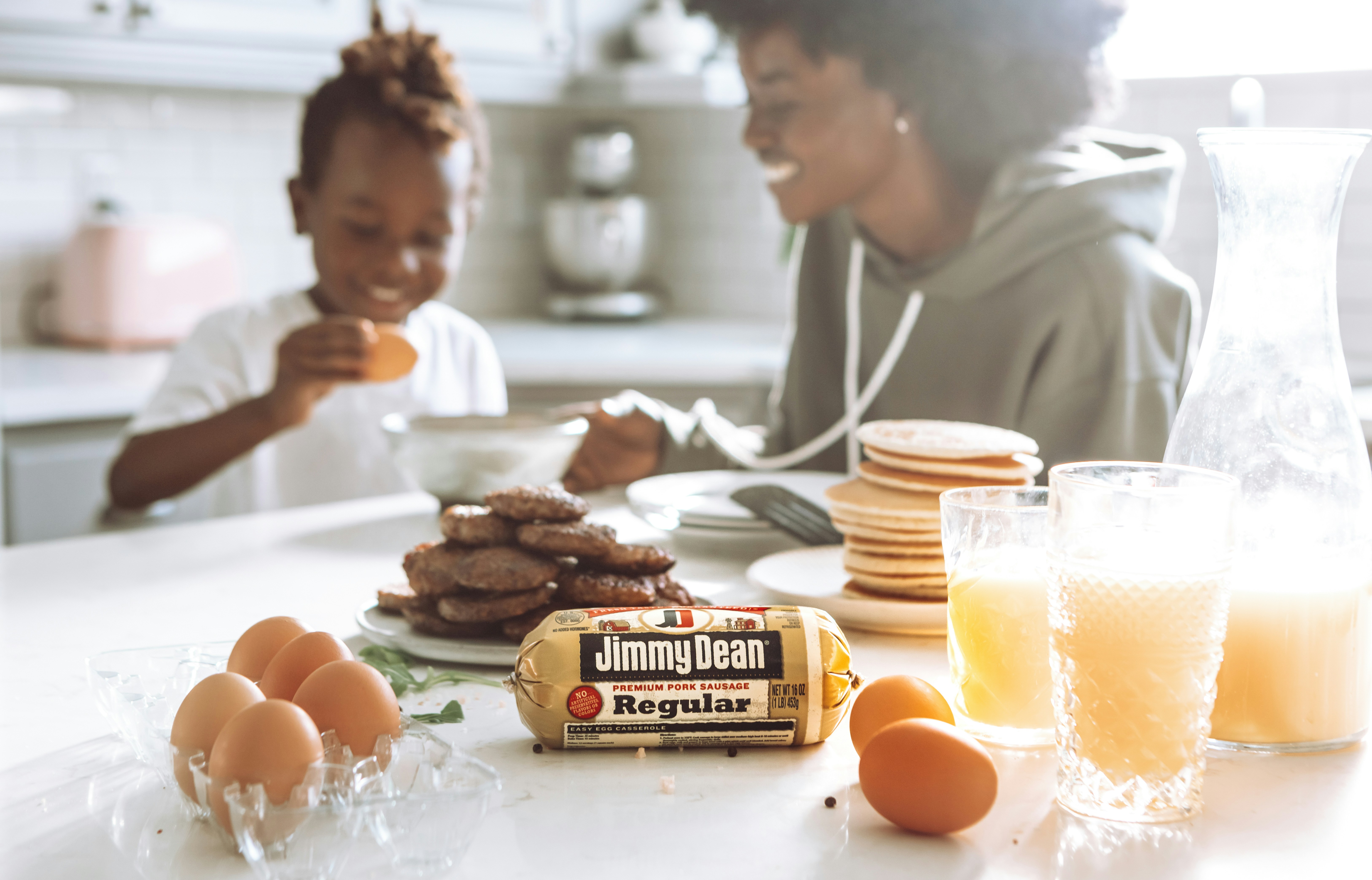 girl in white long sleeve shirt eating burger