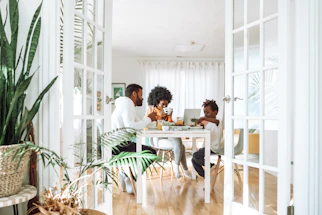 people sitting on chairs in front of table