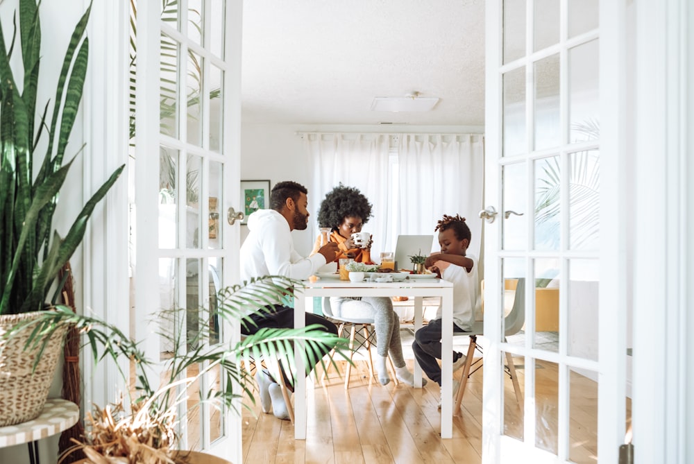 people sitting on chairs in front of table