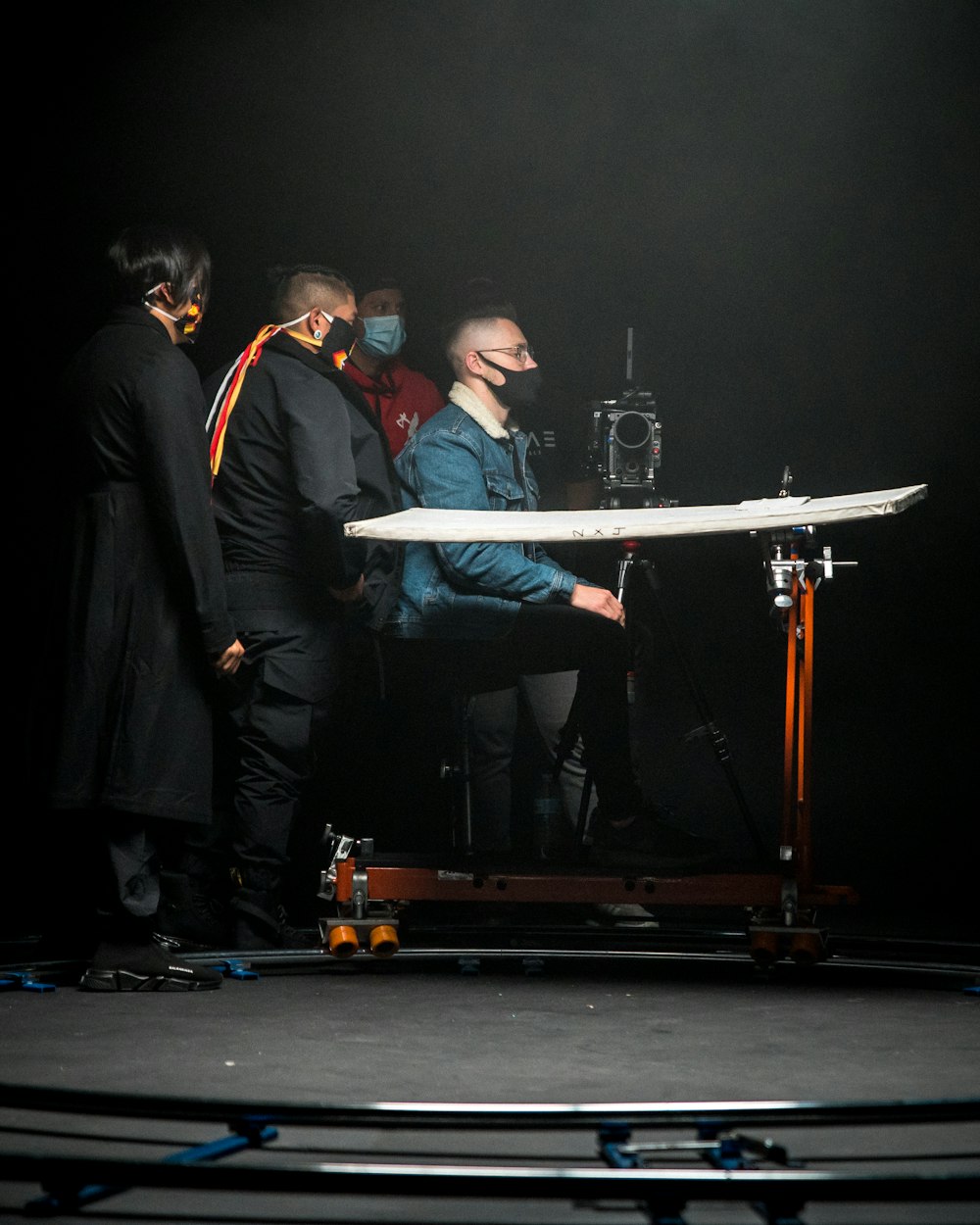 a group of people standing around a table on a stage