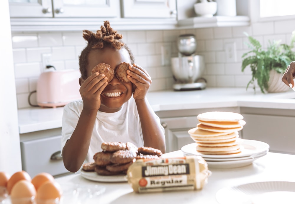 woman in white shirt holding brown bread