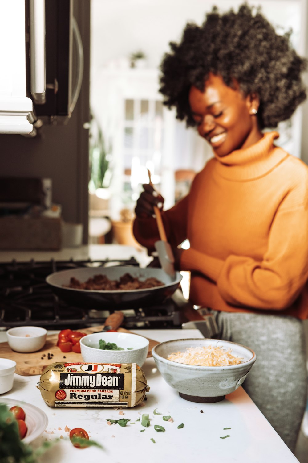 man in orange turtleneck sweater holding chopsticks